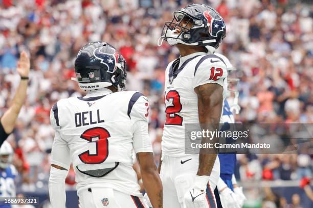 Nico Collins of the Houston Texans celebrates with Tank Dell after scoring a receiving touchdown during the first quarter against the Indianapolis...