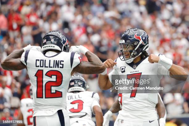 Nico Collins of the Houston Texans celebrates with C.J. Stroud after scoring a receiving touchdown during the first quarter against the Indianapolis...