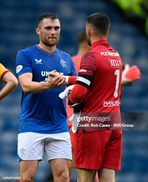 Rangers' John Souttar shakes hands with Motherwell's Liam Kelly during a cinch Premiership match between Rangers and Motherwell at Ibrox Stadium, on...