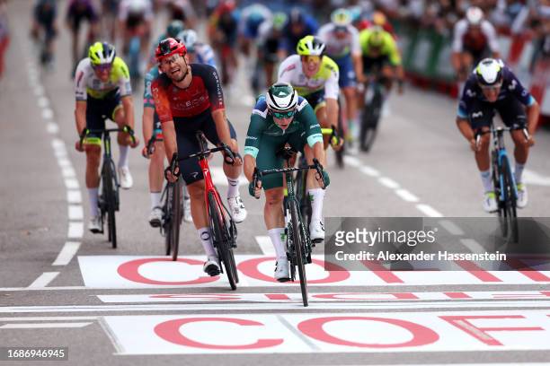 Stage winner Kaden Groves of Australia and Team Alpecin-Deceuninck - Green Points Jersey sprints at finish line ahead of Filippo Ganna of Italy and...