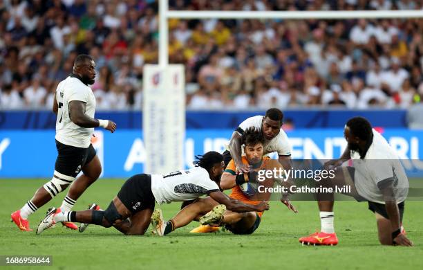 Jordan Petaia of Australia is tackled by Frank Lomani and Josua Tuisova of Fiji during the Rugby World Cup France 2023 match between Australia and...
