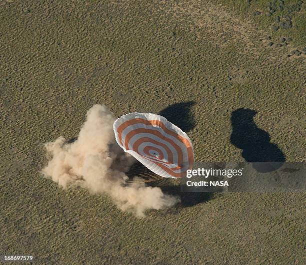 In this handout image provided by NASA,The Soyuz TMA-07M spacecraft lands with Expedition 35 Commander Chris Hadfield of the Canadian Space Agency ,...