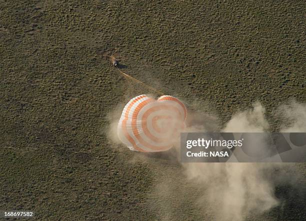 In this handout image provided by NASA,The Soyuz TMA-07M spacecraft lands with Expedition 35 Commander Chris Hadfield of the Canadian Space Agency ,...