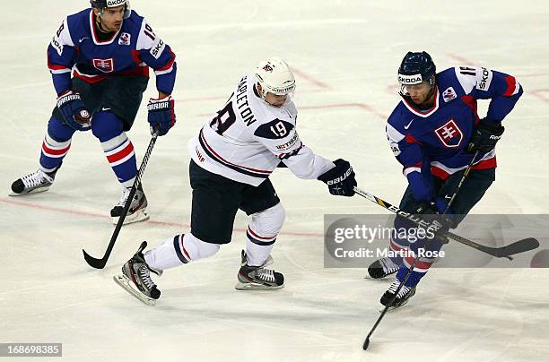 Roman Kukumberg of Slovakia and Tim Stapleton of USA battle for the puck during the IIHF World Championship group H match between Slovakia and USA at...