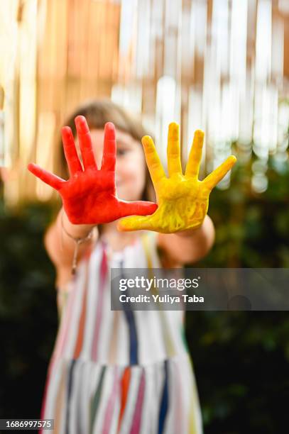 close up of painted hands of a girl. - baby paint hand imagens e fotografias de stock