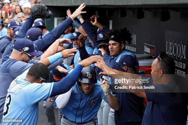 Brandon Lowe of the Tampa Bay Rays celebrates in the dugout with teammates after hitting a home run against the Baltimore Orioles during the first...