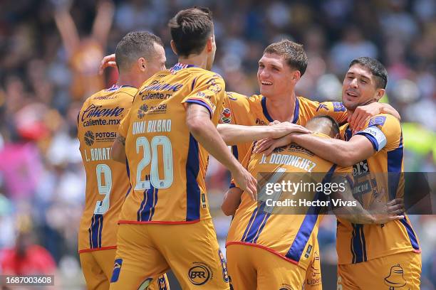 Julio Cesar Dominguez of Atletico San Luis celebrates with teammates after scoring the team's first goal during the 8th round match between Pumas...