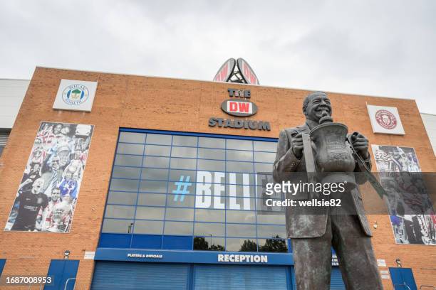 dave whelan statue in front of the the dw stadium - english premier league trophy stock pictures, royalty-free photos & images
