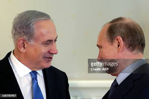 Russia's President Vladimir Putin and Israeli Prime Minister Benjamin Netanyahu speak during their meeting at Putin's residence in the Black Sea...