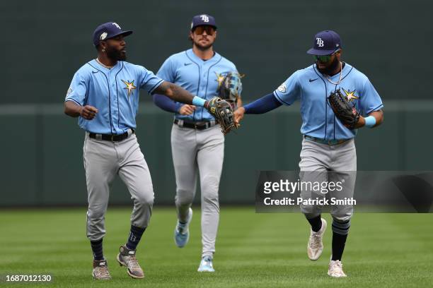Manuel Margot of the Tampa Bay Rays celebrates with teammate Randy Arozarena after making a catch on a hit by the Baltimore Orioles during the second...