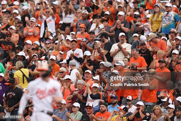 Fans cheer after Austin Hays of the Baltimore Orioles hit an RBI single against the Tampa Bay Rays during the fourth inning at Oriole Park at Camden...