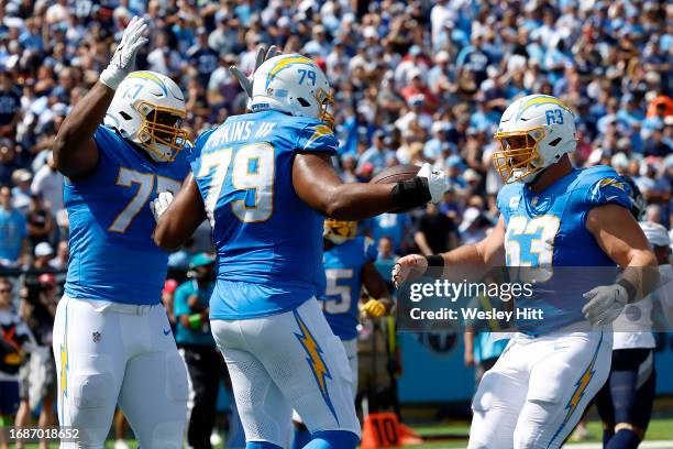 Zion Johnson of the Los Angeles Chargers, Trey Pipkins III of the Los Angeles Chargers and Corey Linsley of the Los Angeles Chargers celebrates after...