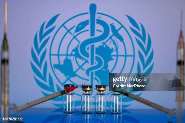 World Health Organization displayed on screen with pharmacy medical syringe and vaccine vial. Seen in this photo illustration, in Brussels, Belgium,...