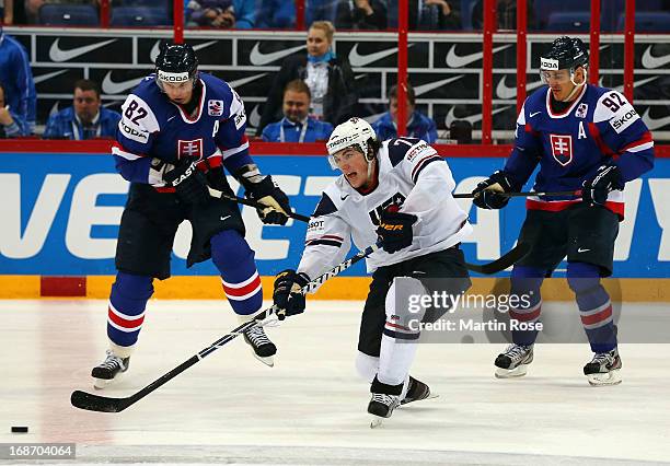 Tomas Kopecky and Branko Radivojevic of Slovakia and TJ Oshie of USA battle for the puck during the IIHF World Championship group H match between...