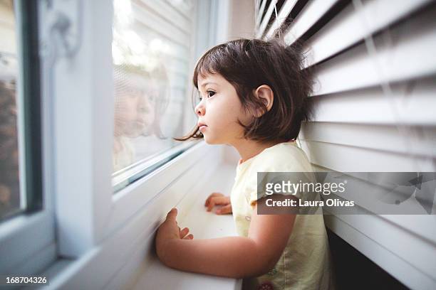 toddler girl by window - child waiting stock pictures, royalty-free photos & images