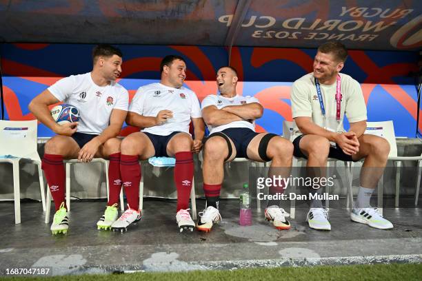 Ben Youngs, Jamie George, Ben Earl and Owen Farrell of England laugh on the substitutes bench prior to the Rugby World Cup France 2023 match between...
