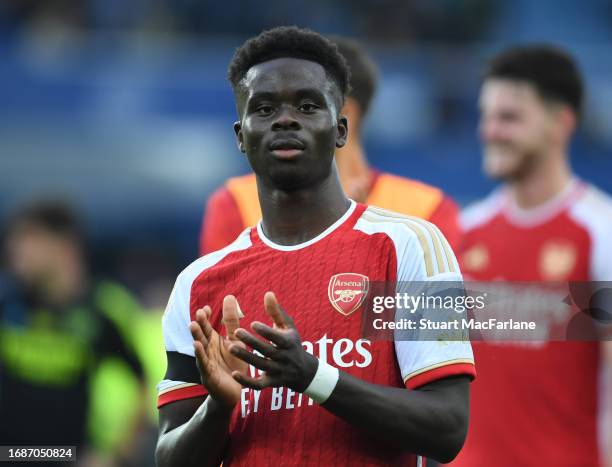 Bukayo Saka applauds the Arsenal fans after the Premier League match between Everton FC and Arsenal FC at Goodison Park on September 17, 2023 in...