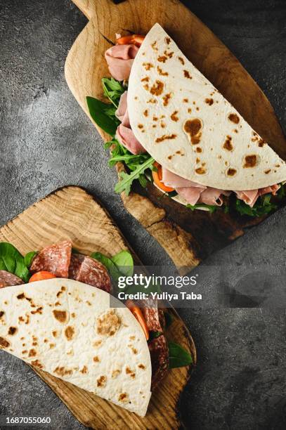 italian street food. tasty flatbread with ham and vegetables. - prosciutto wrapped stock pictures, royalty-free photos & images