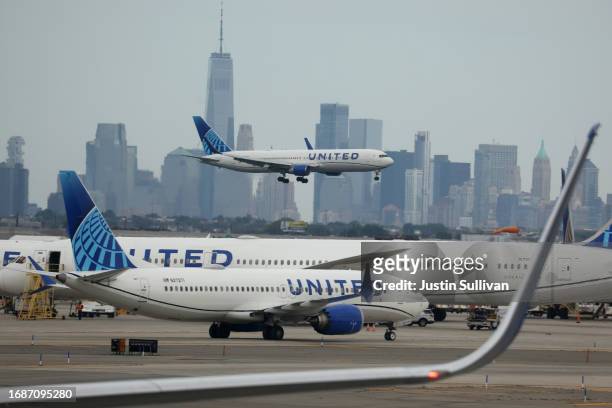 United Airlines plane lands at Newark Liberty International Airport in front of the New York skyline on September 17, 2023 in Newark, New Jersey.