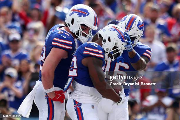 Dawson Knox of the Buffalo Bills and Trent Sherfield of the Buffalo Bills celebrate with Damien Harris of the Buffalo Bills after Harris' touchdown...