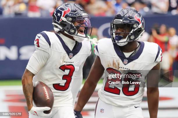 Tank Dell of the Houston Texans celebrates a receiving touchdown with Devin Singletary during the fourth quarter against the Indianapolis Colts at...