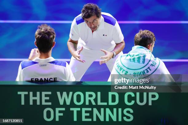 Sebastian Grosjean of Team France speaks with Nicolas Mahut and Edouard Roger-Vasselin during the Davis Cup Finals Group Stage at AO Arena on...