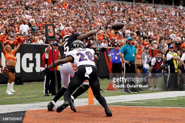 Tee Higgins of the Cincinnati Bengals catches a touchdown pass while defended by Ronald Darby of the Baltimore Ravens during the fourth quarter at...