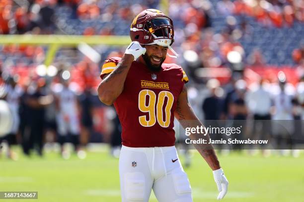 Montez Sweat of the Washington Commanders laughs prior to a game against the Denver Broncos at Empower Field At Mile High on September 17, 2023 in...