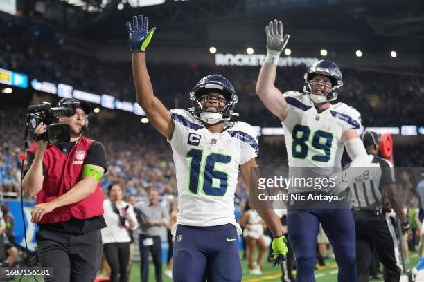 Tyler Lockett and Will Dissly of the Seattle Seahawks celebrates a win over the Detroit Lions at Ford Field on September 17, 2023 in Detroit,...