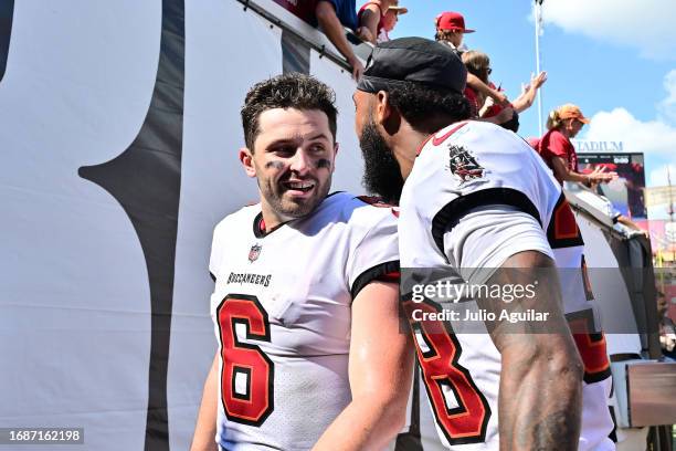 Baker Mayfield of the Tampa Bay Buccaneers talks to Derrek Pitts of the Tampa Bay Buccaneers after their 27-17 win against the Chicago Bears at...