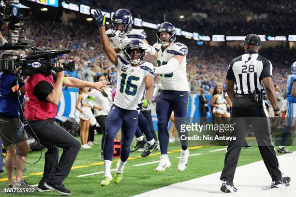 Tyler Lockett and Will Dissly of the Seattle Seahawks celebrates a win over the Detroit Lions at Ford Field on September 17, 2023 in Detroit,...