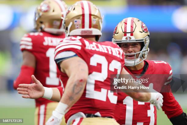 Brock Purdy celebrates a touchdown by Christian McCaffrey of the San Francisco 49ers during the first quarter against the Los Angeles Rams at SoFi...