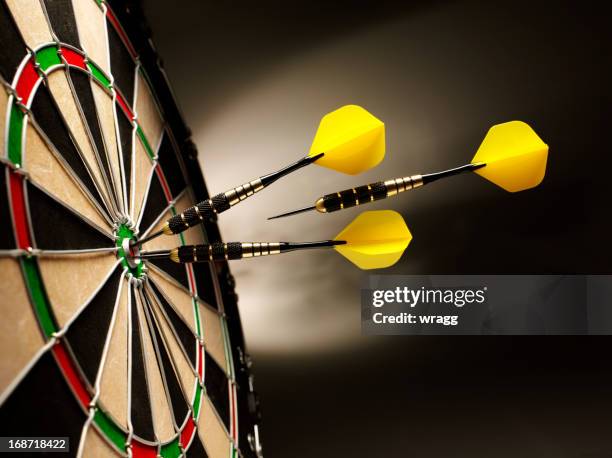 on target in darts - darts stock pictures, royalty-free photos & images