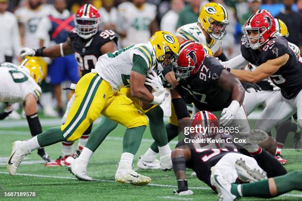 Dillon of the Green Bay Packers runs the ball against Grady Jarrett of the Atlanta Falcons during the fourth quarter at Mercedes-Benz Stadium on...