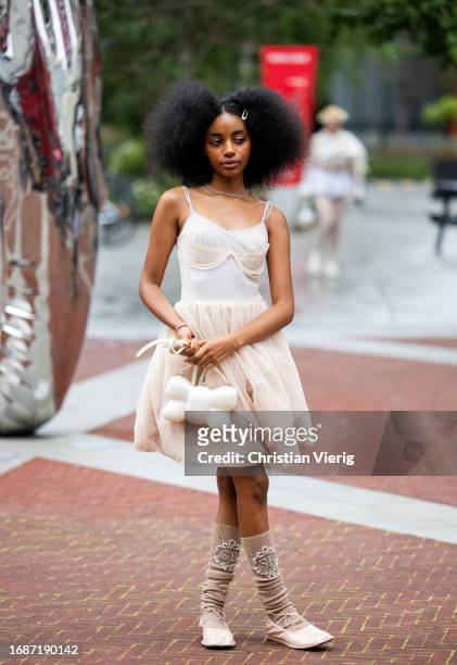 Guest is seen wearing ruffled skirt, shirt, bag outside Simone Rocha during London Fashion Week September 2023 on September 17, 2023 in London,...
