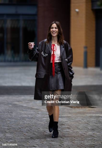 Alexa Chung is seen wearing brown mini skirt, coat outside Simone Rocha during London Fashion Week September 2023 on September 17, 2023 in London,...