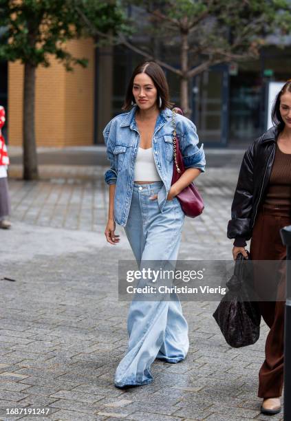 Tiffany Hsu is seen wearing denim jacket, jeans, red bag outside Simone Rocha during London Fashion Week September 2023 on September 17, 2023 in...