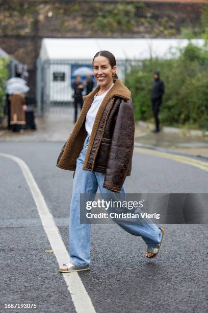 Idalia Salsamendi is seen wearing brown shearling jacket, denim jeans, white shirt outside Holzweiler during London Fashion Week September 2023 on...