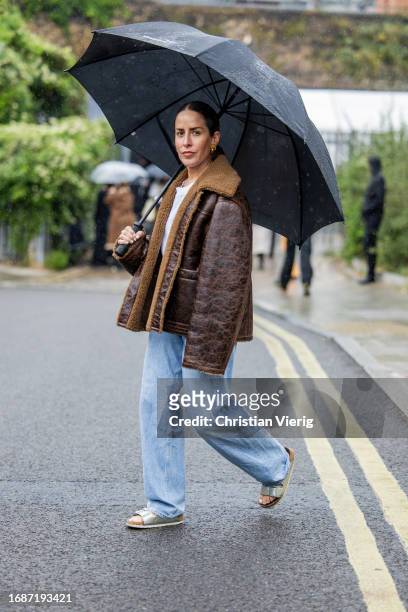 Idalia Salsamendi is seen wearing brown shearling jacket, denim jeans, white shirt outside Holzweiler during London Fashion Week September 2023 on...