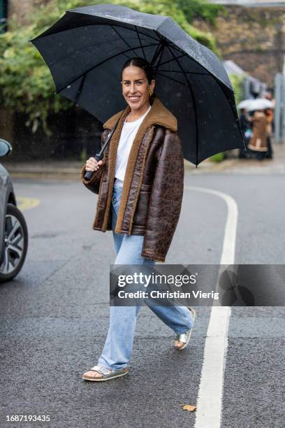 Idalia Salsamendi is seen wearing brown shearling jacket, denim jeans, white shirt outside Holzweiler during London Fashion Week September 2023 on...