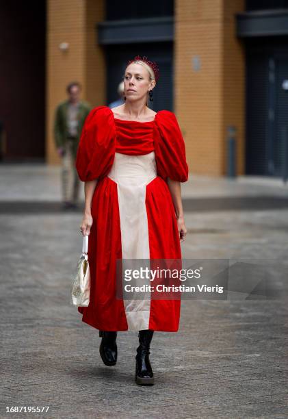 Guest is seen wearing two tone red beige dress outside Simone Rocha during London Fashion Week September 2023 on September 17, 2023 in London,...