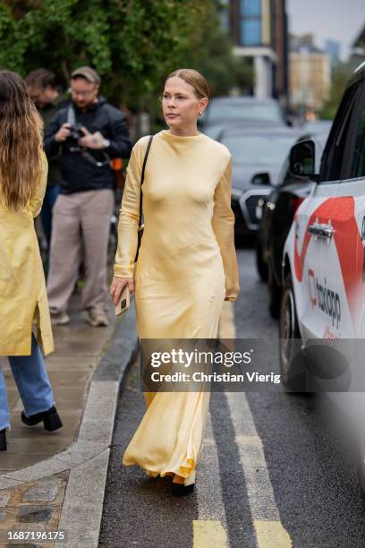 Jessie Bush is seen wearing yellow dress outside Holzweiler during London Fashion Week September 2023 on September 17, 2023 in London, England.