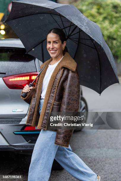 Idalia Salsamendi is seen wearing brown shearling jacket, denim jeans, white shirt outside Holzweiler during London Fashion Week September 2023 on...