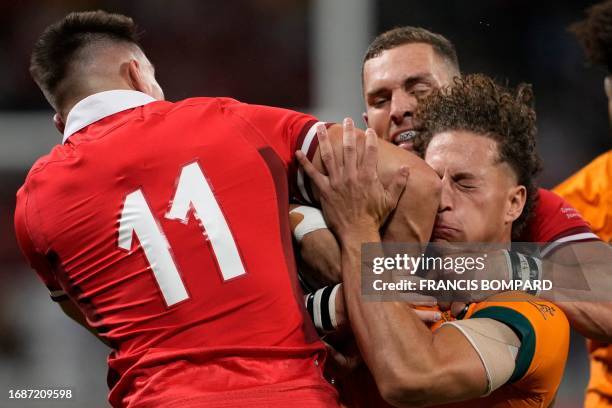 Wales' left wing Josh Adams collides with Australia's wing Mark Nawaqanitawase during the France 2023 Rugby World Cup Pool C match between Wales and...