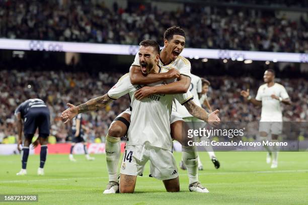 Joselu of Real Madrid celebrates with team mate Jude Bellingham after scoring their sides second goal during the LaLiga EA Sports match between Real...