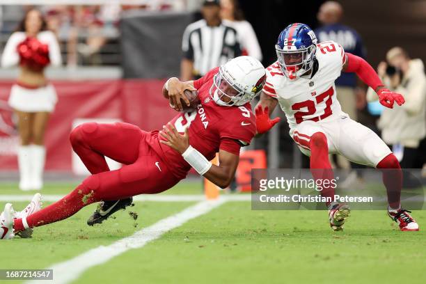Joshua Dobbs of the Arizona Cardinals runs for a touchdown during the second quarter while defended by Jason Pinnock of the New York Giants at State...