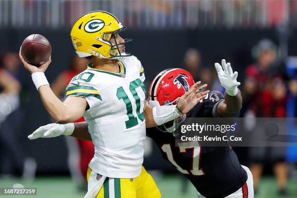 Jordan Love of the Green Bay Packers throws a pass while being defended by Arnold Ebiketie of the Atlanta Falcons during the fourth quarter at...