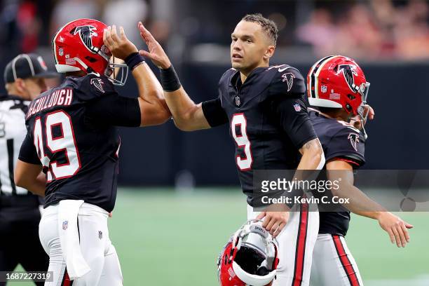 Desmond Ridder of the Atlanta Falcons and Liam McCullough celebrates a win over the Green Bay Packers at Mercedes-Benz Stadium on September 17, 2023...