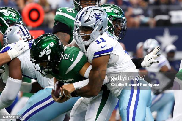 Zach Wilson of the New York Jets is sacked by Micah Parsons of the Dallas Cowboys during the first quarter at AT&T Stadium on September 17, 2023 in...