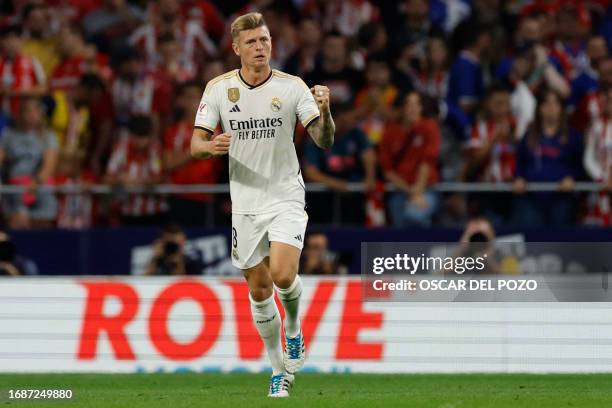 Real Madrid's German midfielder Toni Kroos celebrates scoring his team's first goal during the Spanish Liga football match between Club Atletico de...